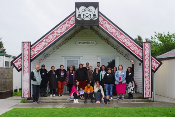 The rōpū posing for a photo in front of Te Māpou marae