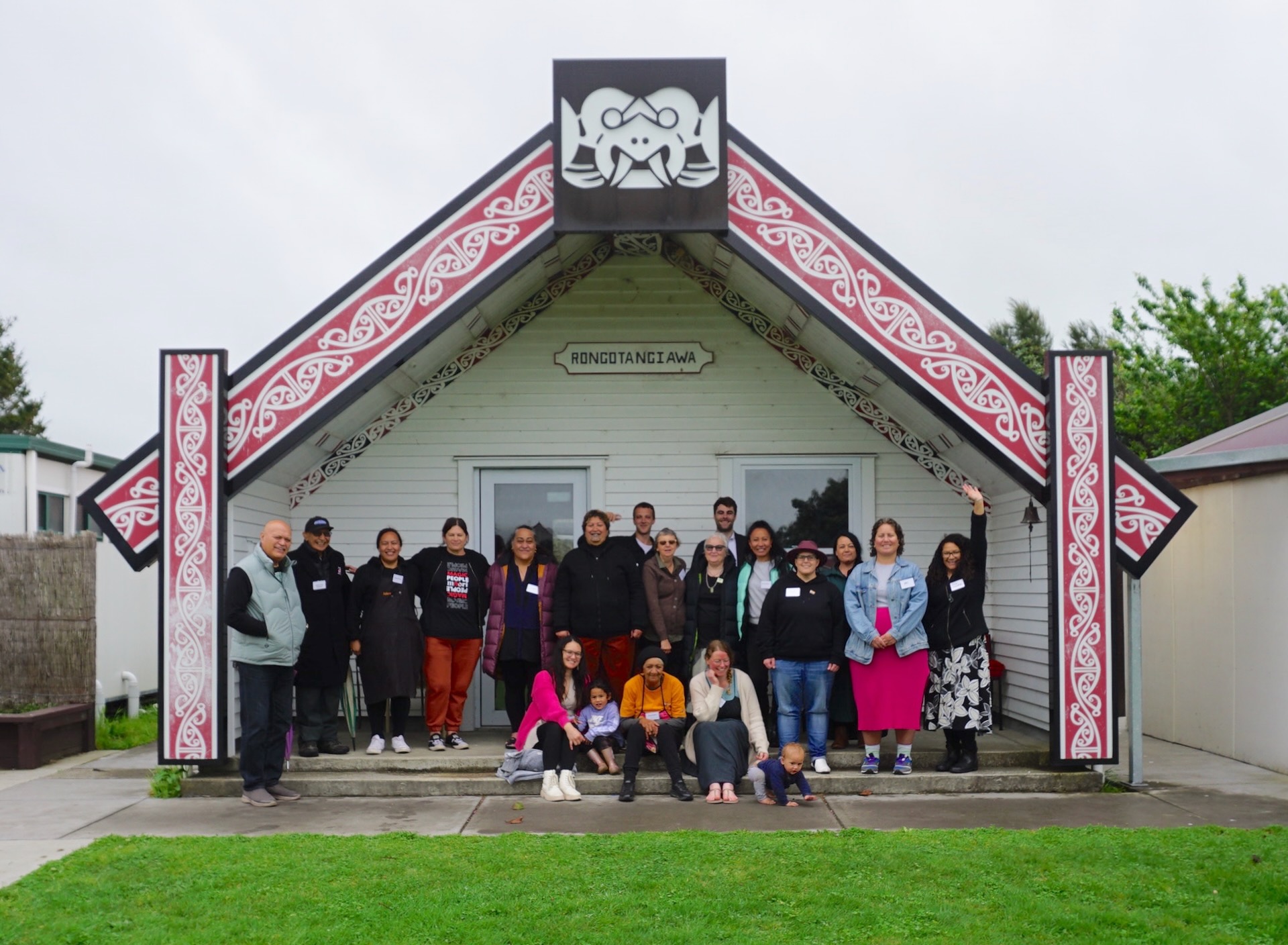 The rōpū posing for a photo in front of Te Māpou marae